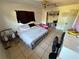 Bedroom featuring neutral tile flooring and a ceiling fan at 460 W Pierce St, Lake Alfred, FL 33850