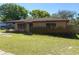 Charming single story brick home with a well-maintained lawn and mature landscaping at 460 W Pierce St, Lake Alfred, FL 33850