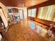An open-concept living area with wood ceiling and a ceiling fan, tile floor and light filled windows at 460 W Pierce St, Lake Alfred, FL 33850