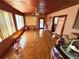 An open-concept living area with wood ceiling, tile floor, a ceiling fan and a door leading to the outside at 460 W Pierce St, Lake Alfred, FL 33850