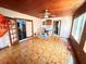 Open living room featuring tile flooring, a ceiling fan, and multiple entryways providing natural light at 460 W Pierce St, Lake Alfred, FL 33850