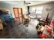 Spacious living room with dark tile flooring, ceiling fan, and natural light from nearby windows at 460 W Pierce St, Lake Alfred, FL 33850