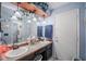 A well-lit bathroom with dual sinks, decor and a tub-shower combo at 530 Heather Ct, Bartow, FL 33830