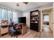 A bedroom featuring a ceiling fan, wood-look floors, and natural light at 530 Heather Ct, Bartow, FL 33830