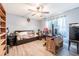 A bedroom featuring a ceiling fan, wood-look floors, and natural light at 530 Heather Ct, Bartow, FL 33830