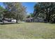 Charming single-story home with well-maintained lawn and mature trees, complemented by an American flag at 530 Heather Ct, Bartow, FL 33830