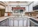 Eat-in kitchen features white cabinets, granite countertops, and modern appliances at 530 Heather Ct, Bartow, FL 33830