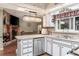 Bright kitchen boasts a fireplace, stainless steel appliances, and stylish decor at 530 Heather Ct, Bartow, FL 33830