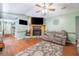 Cozy living room features a stone fireplace, wood floors, and comfortable seating at 530 Heather Ct, Bartow, FL 33830