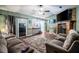 Inviting living room featuring a stone fireplace and sliding doors to the outside at 530 Heather Ct, Bartow, FL 33830