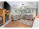 Comfortable living area with stone fireplace, ceiling fan, and neutral paint at 530 Heather Ct, Bartow, FL 33830