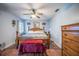 The main bedroom features light blue walls, wood-look floors, and a ceiling fan at 530 Heather Ct, Bartow, FL 33830