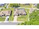 Aerial view of landscaped home with manicured lawn, fence, and driveway at 5638 Bloomfield Blvd, Lakeland, FL 33810