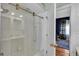 Bathroom includes a tub with shower and a view into an adjacent bedroom with dark blue walls at 5638 Bloomfield Blvd, Lakeland, FL 33810