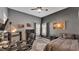 This bedroom features gray walls, a ceiling fan, a bed, a desk, and windows with natural lighting at 5638 Bloomfield Blvd, Lakeland, FL 33810