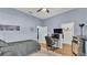 A bedroom with light blue walls and hardwood floors offers a calm space with natural light from the windows at 5638 Bloomfield Blvd, Lakeland, FL 33810