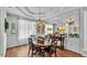 Elegant dining room with tray ceiling, chandelier, and a large mirror at 5638 Bloomfield Blvd, Lakeland, FL 33810
