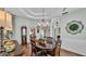 Elegant dining room with tray ceiling, chandelier, view to the front door, and plenty of space at 5638 Bloomfield Blvd, Lakeland, FL 33810