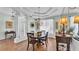 Elegant dining room featuring a chandelier, wood floors, and view to the front door at 5638 Bloomfield Blvd, Lakeland, FL 33810