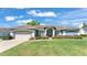 Charming single-story home with a well-manicured lawn and beautiful landscaping at 5638 Bloomfield Blvd, Lakeland, FL 33810