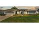 Charming single-story home featuring manicured landscaping, a two-car garage, and classic architectural details at 5638 Bloomfield Blvd, Lakeland, FL 33810