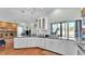 Spacious kitchen featuring white cabinetry, granite countertops, stainless steel appliances, and view to Gathering room at 5638 Bloomfield Blvd, Lakeland, FL 33810