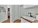 Laundry area with a sink, a butcher block counter, and a door leading to other parts of the house at 5638 Bloomfield Blvd, Lakeland, FL 33810