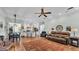Open living area connects kitchen, dining, and living spaces with hardwood floors and ceiling fan at 5638 Bloomfield Blvd, Lakeland, FL 33810