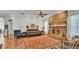 Traditional living room boasts a brick fireplace, wood floors, and comfortable seating arrangement at 5638 Bloomfield Blvd, Lakeland, FL 33810