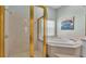 Bright bathroom with a soaking tub, glass enclosed shower, and tile floor at 5638 Bloomfield Blvd, Lakeland, FL 33810