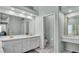 Large bathroom with tile floor, dual sink vanity, and separate toilet room at 5638 Bloomfield Blvd, Lakeland, FL 33810
