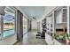 Bright workout and patio area with tile floor, pass-through granite counter top, ceiling fan and pool view at 5638 Bloomfield Blvd, Lakeland, FL 33810