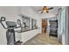Bright patio with tile floor, workout equipment, granite counter top pass-through, and view to fireplace at 5638 Bloomfield Blvd, Lakeland, FL 33810