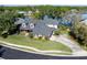 Waterfront property featuring mature landscaping, a well maintained lawn, and access to the water at 5789 Lake Victoria Dr, Lakeland, FL 33813