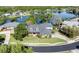 Aerial view of a stunning home on a lush lot with lake views and a circular driveway at 5789 Lake Victoria Dr, Lakeland, FL 33813