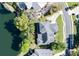 Aerial view of the property, showcasing its position on a lake with a large driveway and mature trees at 5789 Lake Victoria Dr, Lakeland, FL 33813
