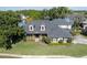 Aerial view of a two-story home with a manicured lawn in a lake community at 5789 Lake Victoria Dr, Lakeland, FL 33813