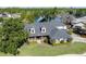 Sprawling lakefront home with manicured lawn, mature trees, and a picturesque water view at 5789 Lake Victoria Dr, Lakeland, FL 33813