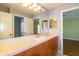 Bathroom featuring wood vanity and double door access to other rooms at 5789 Lake Victoria Dr, Lakeland, FL 33813