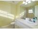 Bright bathroom featuring a white vanity, white tile, and shower with window at 5789 Lake Victoria Dr, Lakeland, FL 33813
