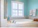 The bathroom has a large tub surrounded by tile with a large window above the tub at 5789 Lake Victoria Dr, Lakeland, FL 33813