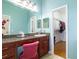 Bathroom featuring granite counters, dual mirrors, walk in closet and a pink chair at 5789 Lake Victoria Dr, Lakeland, FL 33813