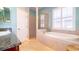 This bright bathroom features a large tub and a glass enclosed shower at 5789 Lake Victoria Dr, Lakeland, FL 33813