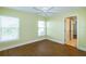 This bedroom features hardwood floors, two windows, and an overhead ceiling fan at 5789 Lake Victoria Dr, Lakeland, FL 33813