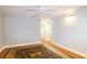 A spacious bedroom featuring wood floors, ceiling fan, and a stylish area rug at 5789 Lake Victoria Dr, Lakeland, FL 33813