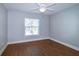 Neutral bedroom featuring a window with blinds and hardwood floors at 5789 Lake Victoria Dr, Lakeland, FL 33813