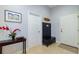 Entryway with console table, hall tree and neutral-colored tile flooring at 5789 Lake Victoria Dr, Lakeland, FL 33813