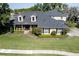 Charming home featuring lush landscaping, dormer windows, and a welcoming covered front porch with decorative columns at 5789 Lake Victoria Dr, Lakeland, FL 33813