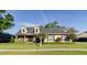 Charming two-story home featuring a well-manicured lawn and beautiful landscaping at 5789 Lake Victoria Dr, Lakeland, FL 33813