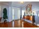 Elegant foyer featuring hardwood floors, decorative mirror, and ample natural light at 5789 Lake Victoria Dr, Lakeland, FL 33813